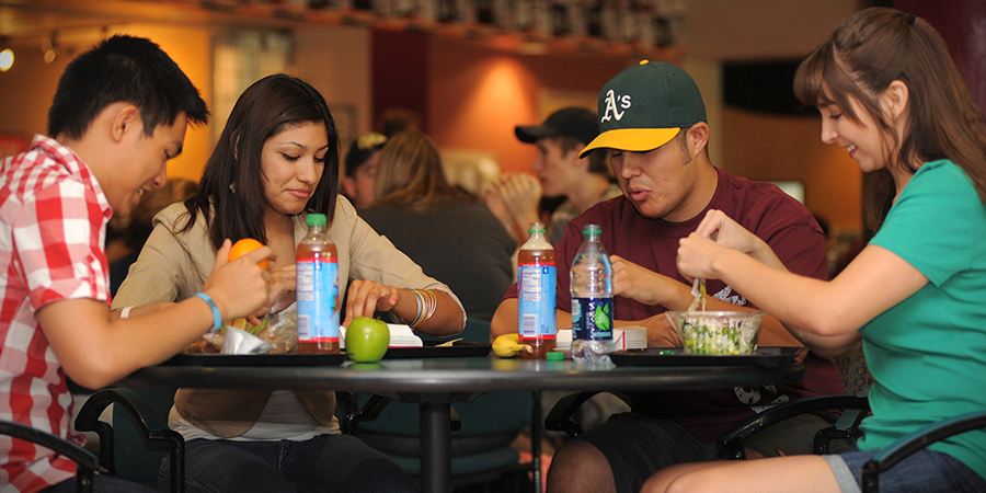 a group of students eating lunch at a table