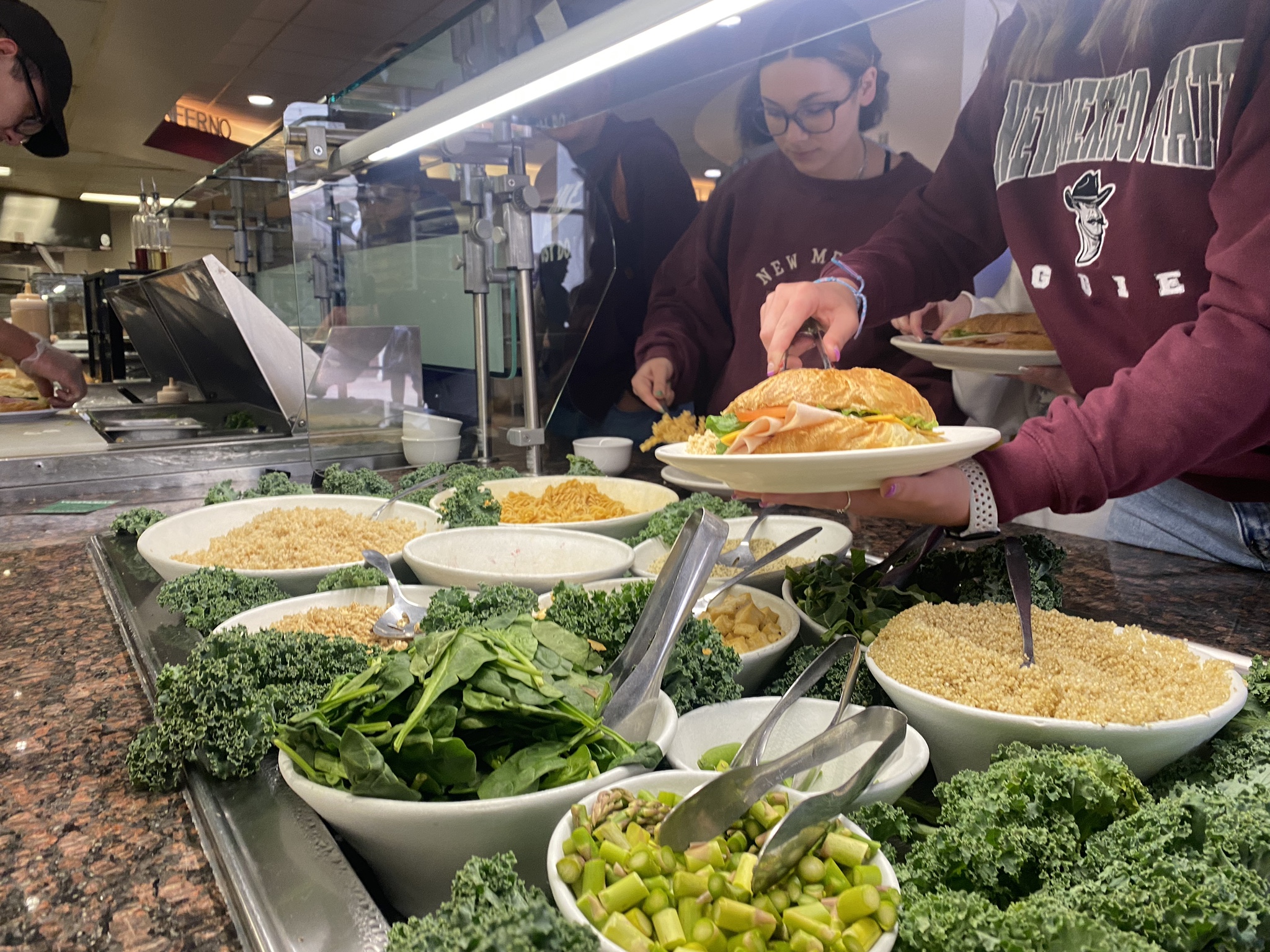 Students serving themselves from a food station